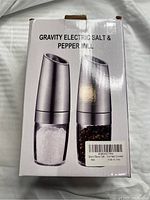 Box packaging showing brand new Gravity Electric Salt & Pepper Mill set with image of two mills, one for salt and one for pepper.