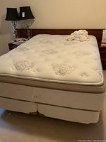 Front view of Beautyrest pillow top mattress on split boxspring and metal frame