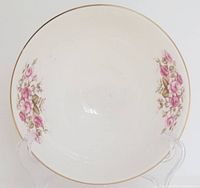 Top view of Royal Doulton footed bowl showing floral pattern inside and gold rim.