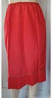 Front view of the red vintage half slip showing smooth fabric, elastic waistband, and ribbed hem detail.