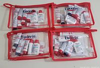Four clear red zippered pouches, each containing multiple Eucerin Medical Skin Science sample tubes and bottles with red and white branding.