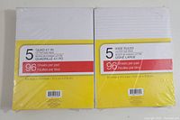 Two packages of letter size pads, one pack of 5 quad ruled pads and one pack of 5 wide ruled pads, showing front packaging with sheet counts and dimensions.
