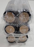 Photo showing the bottom of six Revlon Super Lustrous lipsticks with the shade number and name visible as 041 Gold Goddess, all sealed in plastic wrap.