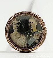 Close-up of the hat pin top showing the photographic image of King George VI and Queen Elizabeth inside a round metal setting.