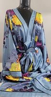 Front view of the full length floral dressing robe on mannequin showing the pattern and tied belt.