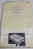 Original packaging for Imperial Damask Dutchess Chrysanthemum tablecloth and napkins in pale yellow, unopened.