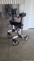 Front side view of BeYour upright walker with padded armrests, ergonomic handles, and bag under seat.