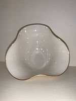 Top view of white Lenox porcelain bowl showing fluted shape and gold trim along rim.