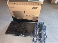 Boxed Acer monitor visible with sealed monitor and accessories on the floor