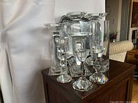 Photo showing all crystal candlesticks with clear faceted designs, and the silver tray in the background.