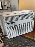 Front view of Danby window A/C unit showing grille, brand name, and control panel.