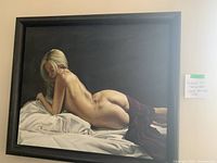 Painting of a reclining female nude in a black distressed wood frame, full view