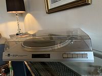 Front angle of Dual CS 530 turntable showing push buttons and dust cover closed.