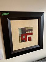First abstract oil painting showing geometric blocks of red, white, brown, and green color. Mounted on beige mat and espresso wide wooden frame. Minor damage visible on frame.