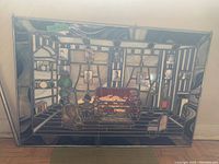 Stained glass panel displaying an interior room scene with seated furniture and multiple small black and white family photos fused into the glass