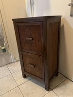 Front and side angled view of vintage wooden two drawer dresser showing bamboo style inlay drawer fronts and rectangular shape