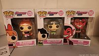 Three Funko Pop Animation The Powerpuff Girls vinyl figures in boxes: Blossom (#125), Buttercup (#127), and Him (#202) lined up together.