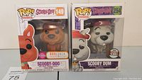 Full view of both Scooby-Doo Funko Pop figures in box: 149 Scooby-Doo Flocked BoxLunch Exclusive and 254 Scooby Dum Specialty Series.