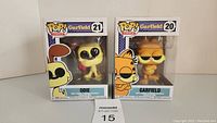 Two boxed Pop! Comics vinyl figures: Garfield #20 and Odie #21 standing side by side.