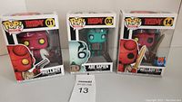 Three boxed Funko Pop! figures: Hellboy (01), Abe Sapien (03), and Hellboy with Sword PX Preview Exclusive (14).