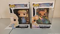 Front view of two boxed Funko Pop! vinyl figures from the Disney Cinderella collection, showing figure #138 Cinderella and #139 Gus Gus in Slipper.