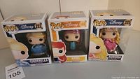 Lot of three Funko Pop vinyl figures of Disney princesses Ariel, Cinderella, and Aurora in boxed packaging.