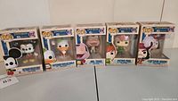 Set of five Funko Pop! vinyl figures in original boxes from Disneyland 65th Anniversary series, showing Matterhorn Bobsleds Mickey, Matterhorn Bobsleds Donald, Mr. Toad, Peter Pan, and Captain Hook.