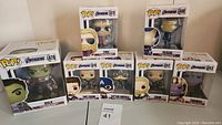 Overview of six boxed Funko Pop figures including Hulk, Tony Stark, Captain America, Thor, Thanos, and Rescue arranged on a table.