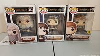 Front view of three boxed Funko Pop Lord of the Rings figures: Gandalf, Frodo Baggins, Samwise Gamgee.