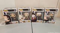 Four boxed Funko Pop! figures from Lord of the Rings including Aragorn, Gollum, Lurtz, and King Aragorn Toys R Us exclusive.