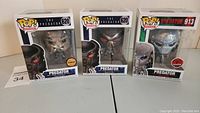 Three Funko Pop! vinyl figures from The Predator movies series in original packaging, showing front boxes with branding and labels.