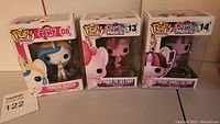 Three My Little Pony Movie Pop vinyl figures in original boxes: Princess Celestia #08, Pinkie Pie Sea Pony #13, Twilight Sparkle Sea Pony #14.