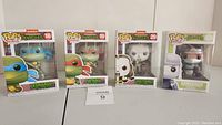 Four boxed Funko Pop Retro Toys figures of Teenage Mutant Ninja Turtles characters Leonardo, Raphael, Casey Jones, and Shredder displayed together.
