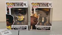 Two original boxed Funko Pop! Rocks figures of The Notorious B.I.G.: one with a crown (number 77) and one with a yellow jersey and sunglasses (number 78).