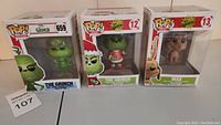 Three Funko Pop! Grinch vinyl figures boxed together showing character and packaging.