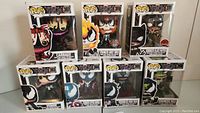 Front and arrangement view showing all seven Funko Pop! Marvel Venom and Venomized figures in boxes.