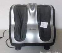 Front view of the foot and calf massager showing the foot slots and branding on the front panel