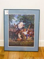 Full front view of the framed Humpty Dumpty poster with blue mat and metal frame against a white wall.