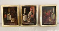 Set of three framed vintage Cutty Shark whisky advertising prints displayed together, showing full designs and frames