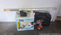Overview of lot showing Wagner 705 Power Steamer box, Black & Decker drill, electrical outlet strip in packaging