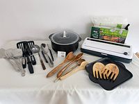 Overview of all items: vacuum sealer with bags, rock crock pieces, utensils