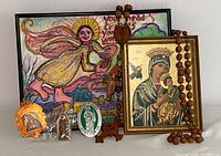 Religious lot group featuring framed MCM Fleck Brothers artwork of Mary and child with wooden bead rosary and framed religious image, small medallions and painted angel artwork.