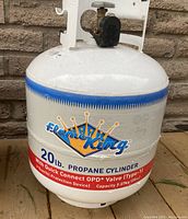 Full view of the white 20 lb. propane cylinder with Flame King branding and capacity details on label.