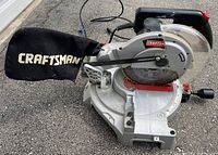 Side angled view of Craftsman 10-inch compound miter saw with dust bag.