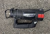 Side view of black Rotozip Rebel spiral saw showing Rebel logo and red button.
