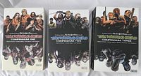 Three hardcover comic books side by side showing The Walking Dead Compendium One, Two, and Three covers featuring series characters.