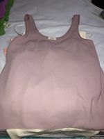 Mauve sleeveless top laid flat showing fabric and design