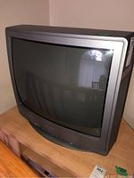 Front view of the gray Sharp CRT television showing the curved screen and lower panel with control buttons.