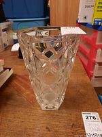 Front view of clear crystal vase showing geometric cuts and faceted design.