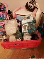 Bin filled with assorted yarn skeins including Bernat Blanket and others in cream, green, and mixed colors.